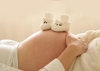 pregnant woman with baby footwear