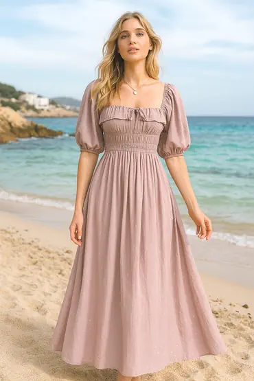 Young mother walking on the beach in a summer dress.