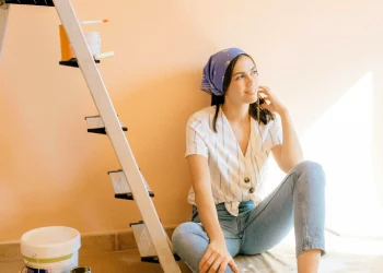 Young mother painting a child's room.
