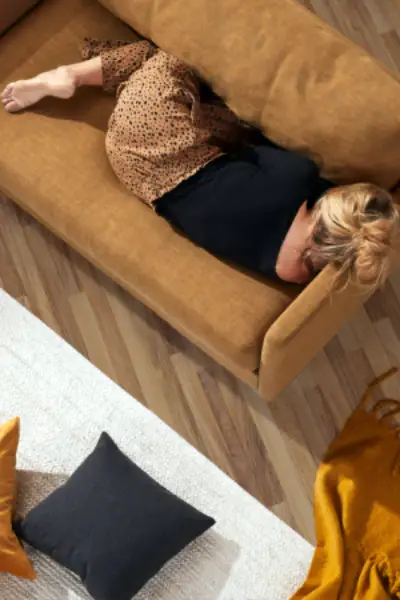 Woman relaxing on a cozy sofa.